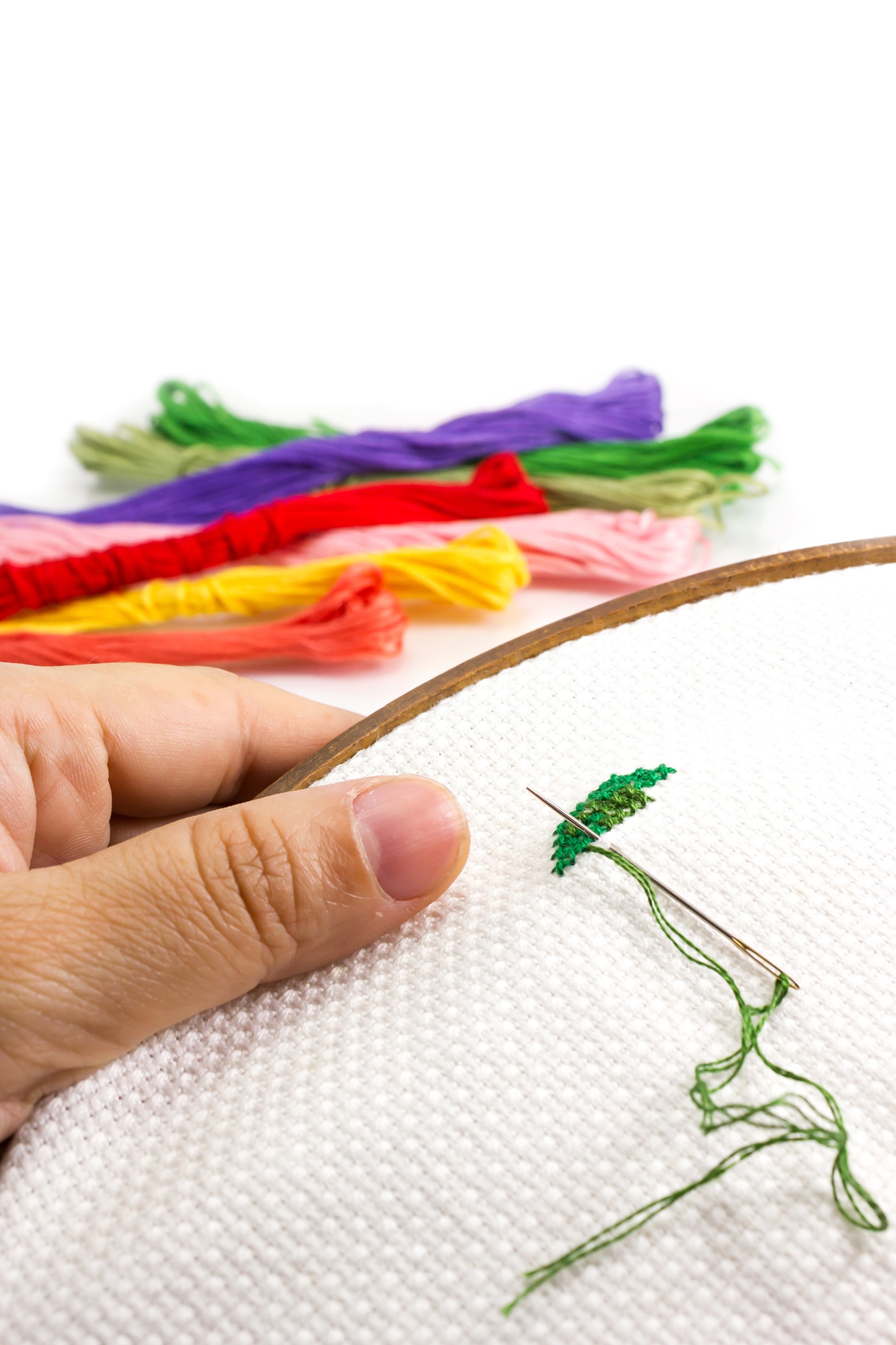 close up of hand embroidery sampler with neon threads
